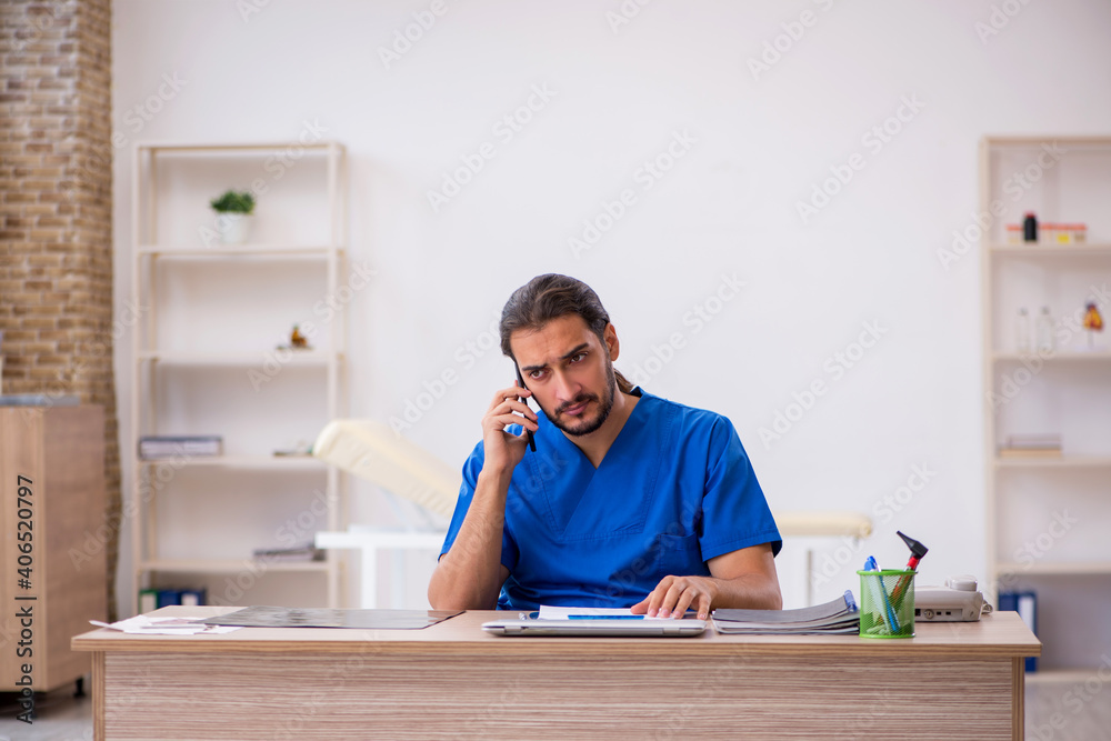 Young male doctor in telemedicine concept Young male doctor in telemedicine concept