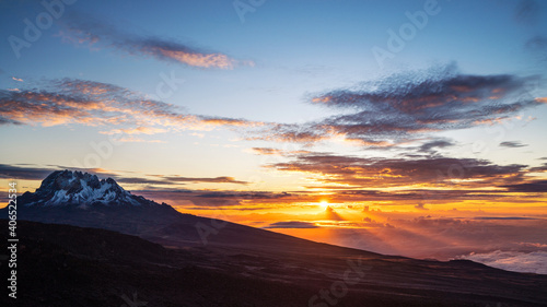 Breathtaking view of sunrise morning sky with Mawenzi mountain peak 5148m - the 4th highest peak in Africa. Kilimanjaro National Park, Tanzania.
