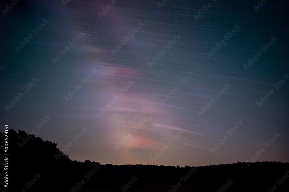 Star trails in the night sky in the forest Star trails in the night sky in the forest