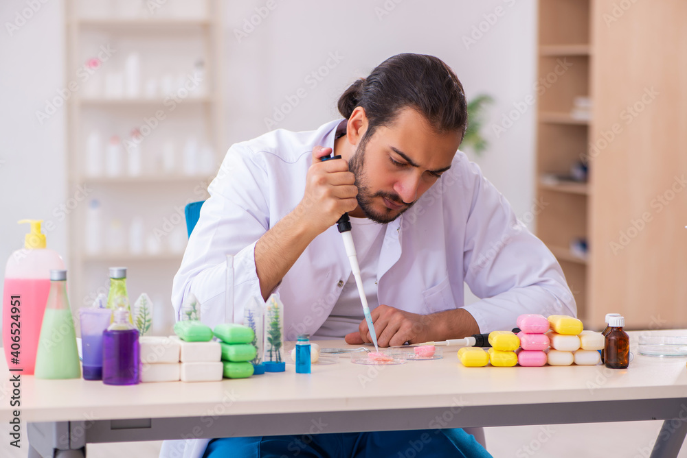 Young male chemist testing soap in the lab Young male chemist testing soap in the lab