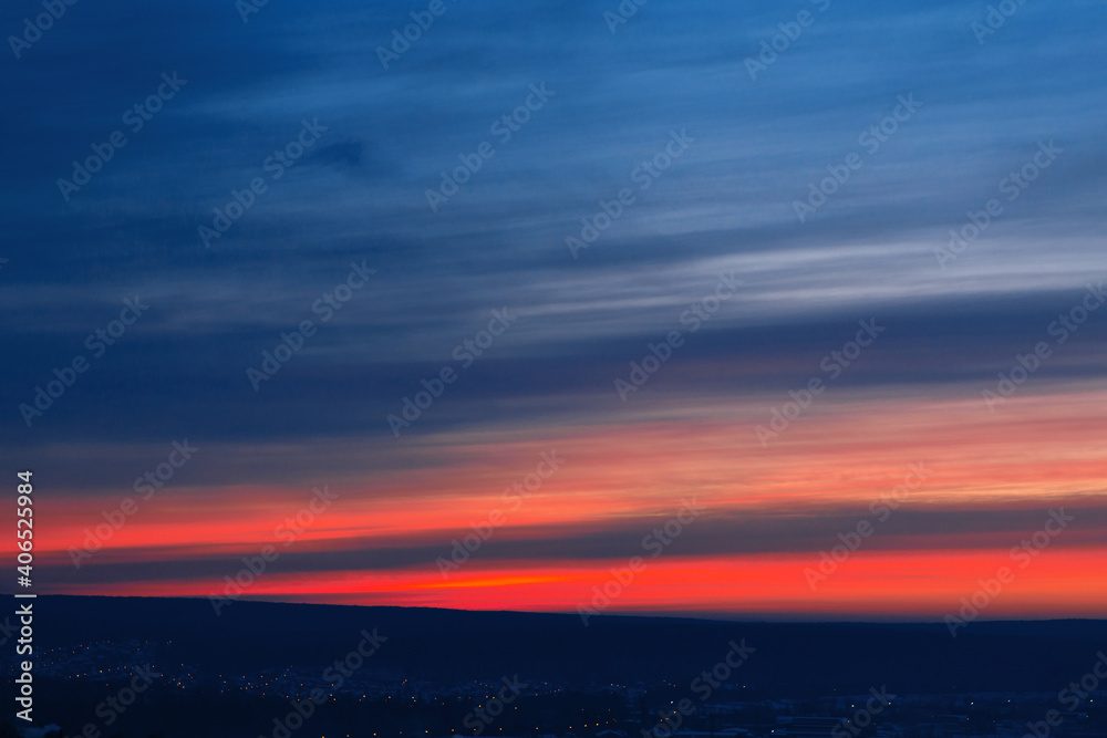 Beautiful sunset sky with stripes of red and blue
