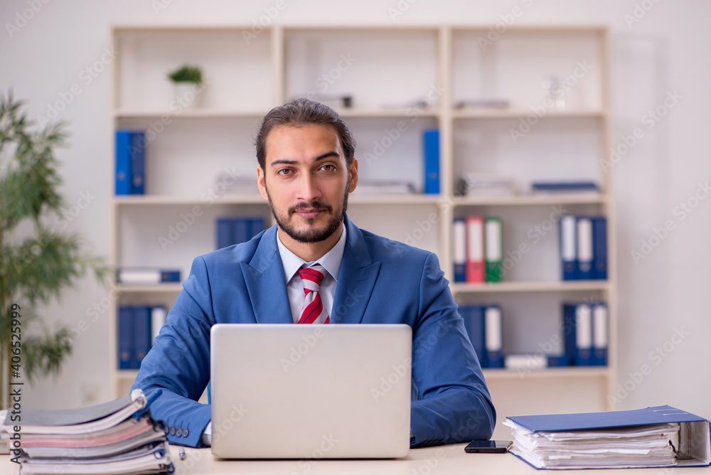 Young male employee working in the office Young male employee working in the office