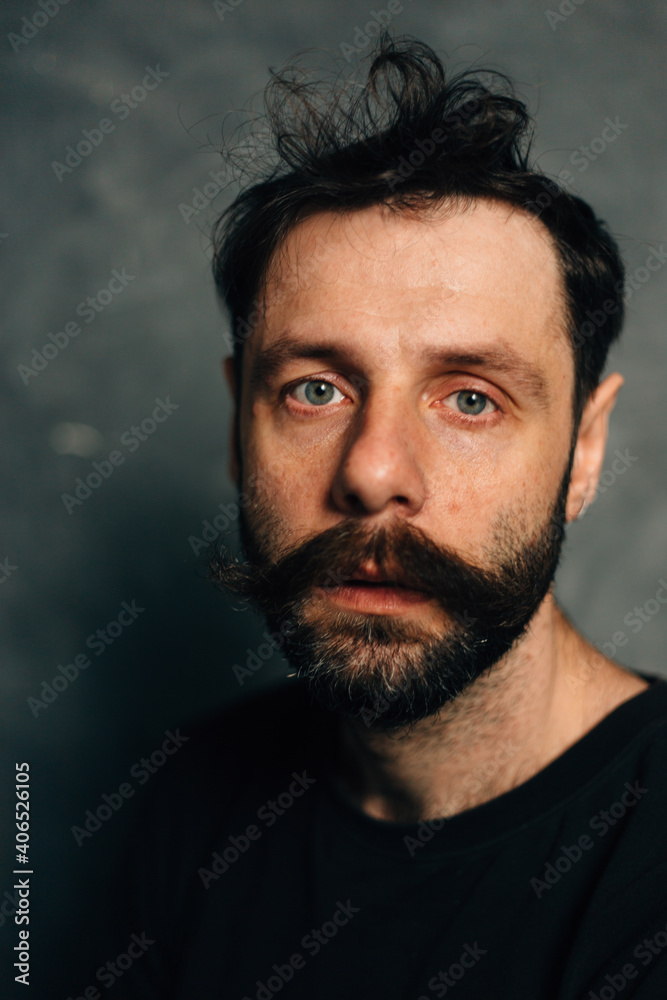 Portrait of a courageous guy with a beard and mustache on a canvas background Portrait of a courageous guy with a beard and mustache on a canvas background