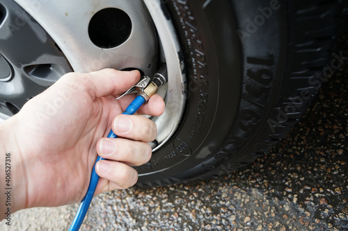 Car tyre pressure checking and inflating with hose