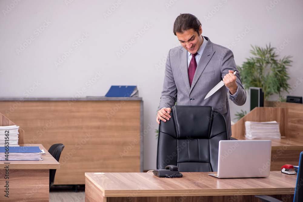 Young businessman employee in bullying concept in the office Young businessman employee in bullying concept in the office