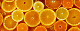 Citrus fruits slices assortment pattern background: orange, lemon  and mandarin. Horizontal web banner. Slice of citrus flat lay texture.