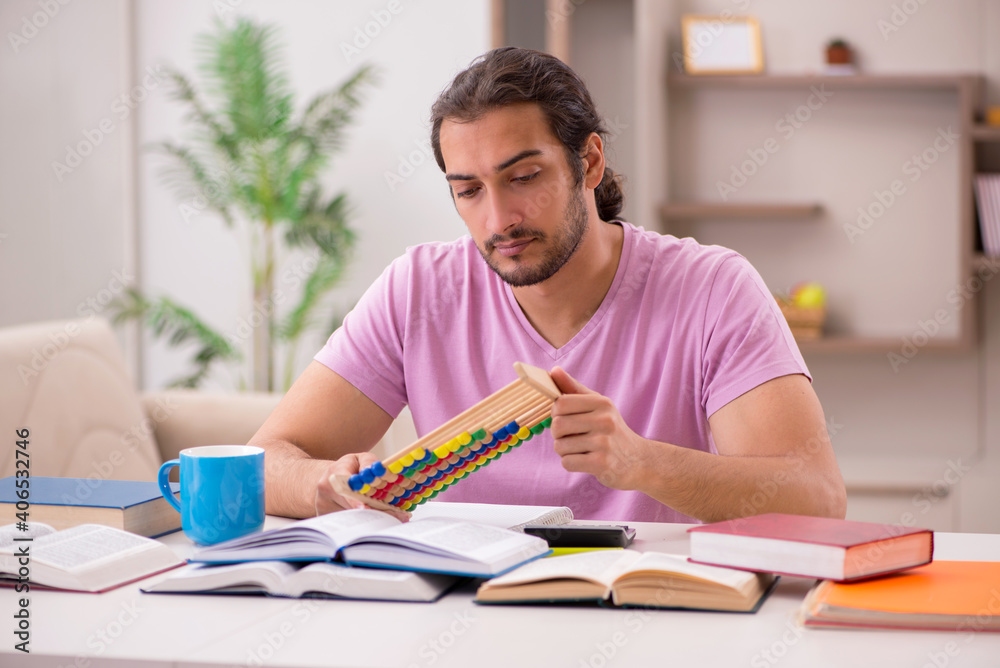 Young male student preparing for exams at home Young male student preparing for exams at home