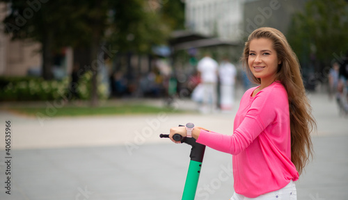 Woman driving scooter in a city