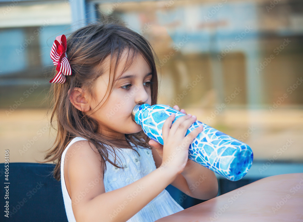 girl drinking from a bottle of water in a cafe Stock Photo Adobe Stock