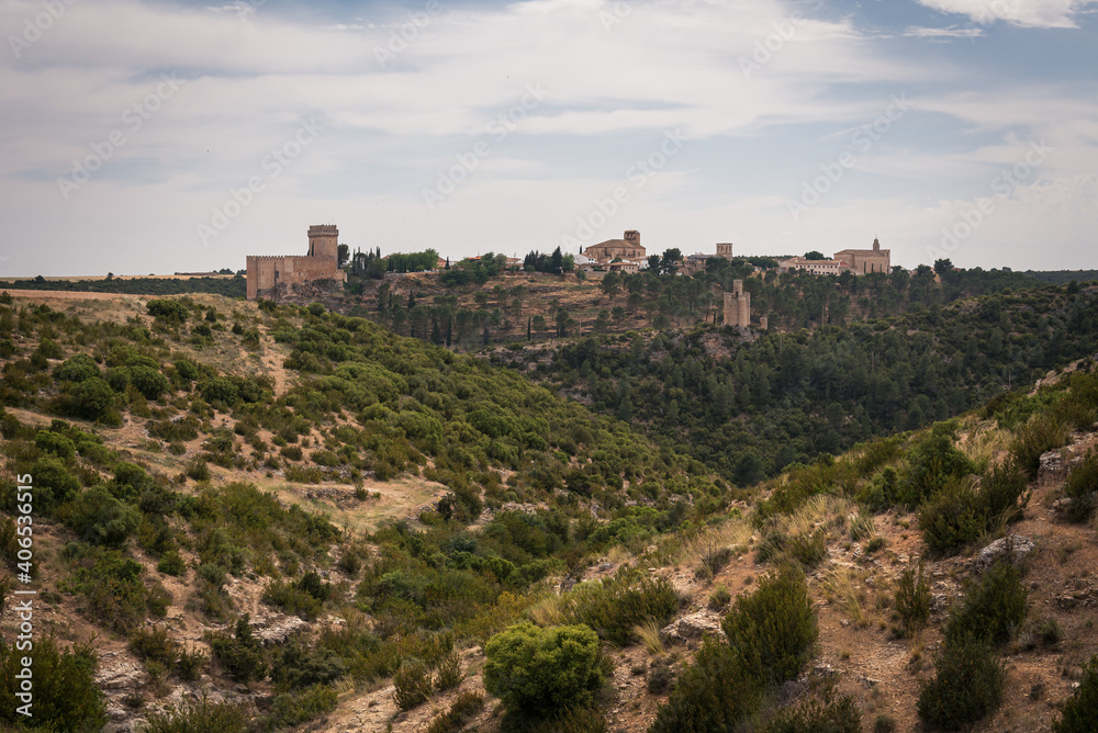 Landscape with the fortified city of Alarcon with its watchtowers and the castle on top of the hill on a cloudy day, Cuenca, Spain