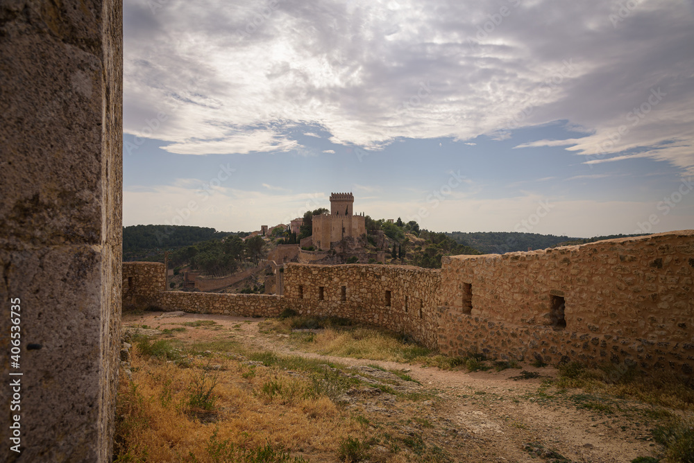 Obraz premium View of the fortified city of Alarcon with its wall and castle from a watchtower on a cloudy day, Cuenca, Spain