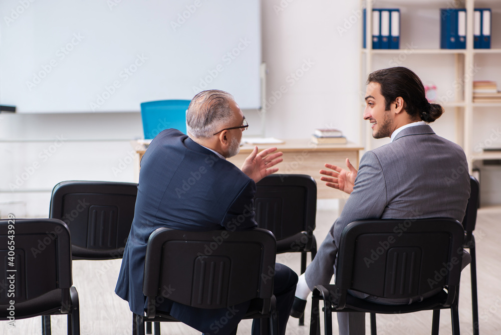 Two businessmen in the classroom in pandemic concept Two businessmen in the classroom in pandemic concept