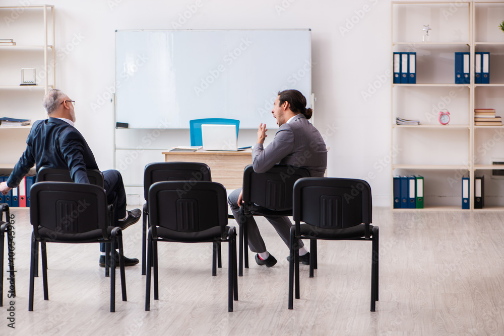 Two businessmen in the classroom in pandemic concept Two businessmen in the classroom in pandemic concept
