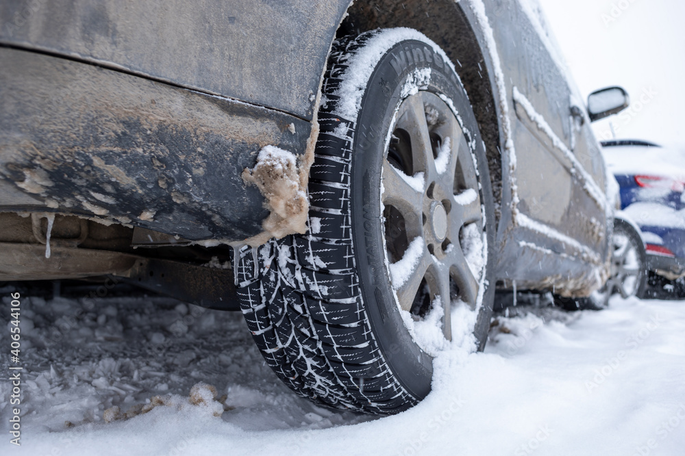 Winter tire. Car on snow road. Tires on snowy highway detail. Winter tire. Car on snow road. Tires on snowy highway detail.