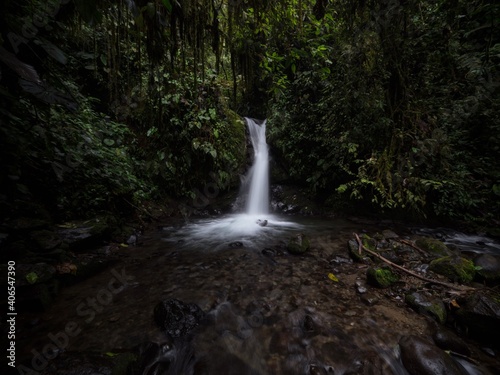 Panorama view of Cascada Azul blue waterfall in tropical rain cloud forest Mindo valley jungle Nambillo Ecuador andes photo