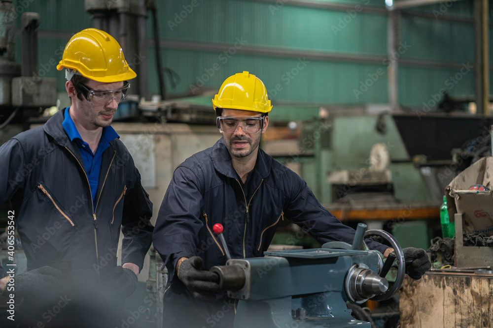 Fototapeta premium Professional worker man. Inspection technician, factory engineer, inspection of the machine condition in the factory. Inspection by technicians, industrial business, production machinery