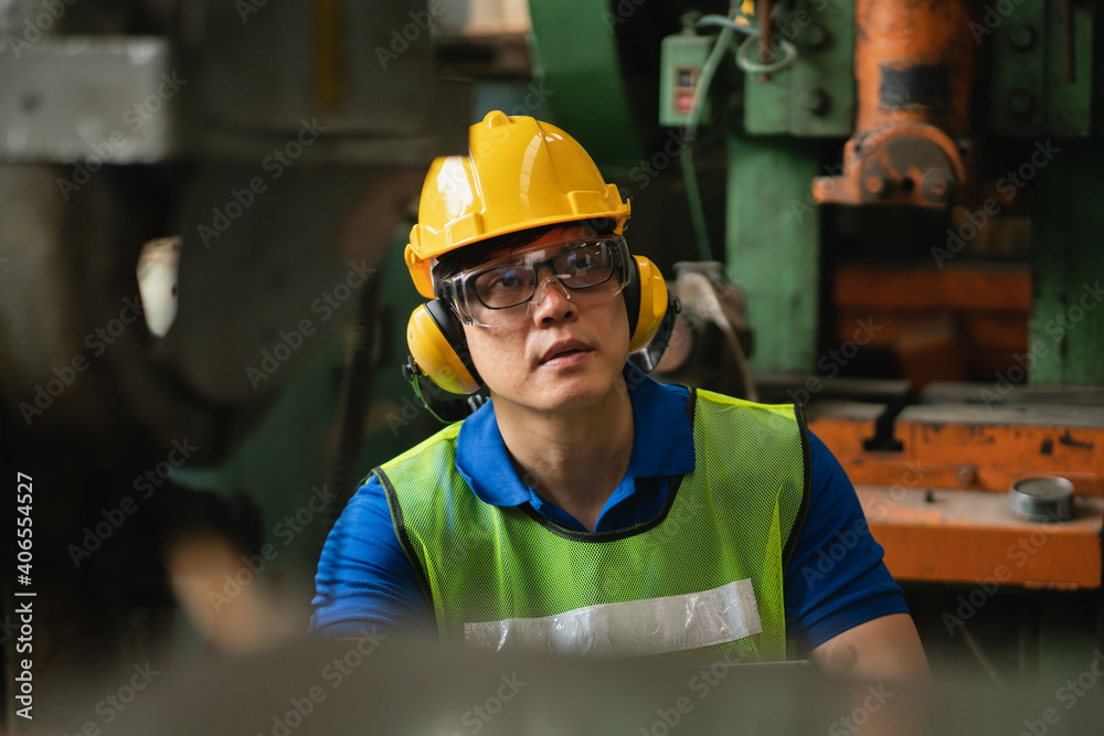 Professional worker asian man. Inspection technician, factory engineer, inspection of the machine condition in the factory. Inspection by technicians, industrial business, production machinery Professional worker asian man. Inspection technician, factory engineer, inspection of the machine condition in the factory. Inspection by technicians, industrial business, production machinery