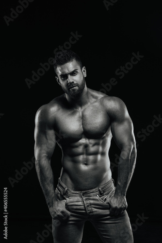 Male fitness model Konstantin Kamynin posing shirtless on black background © Serge Lee