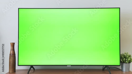 TV Green Screen in living room with tree and lamps. chroma key screen for advertising.