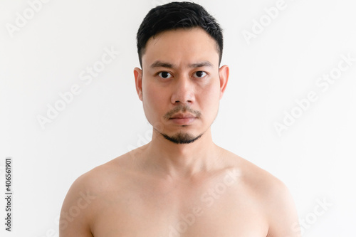 Portrait of topless Asian man with serious face on isolated background.