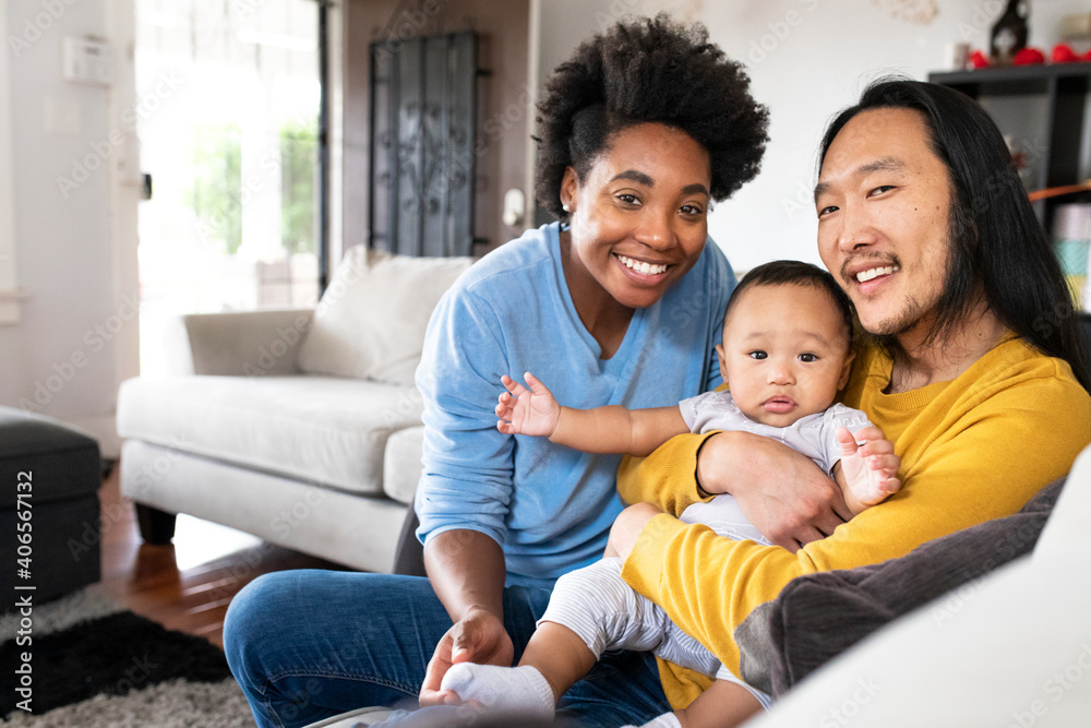 Fototapeta premium Happy multiracial parents spending time with their son