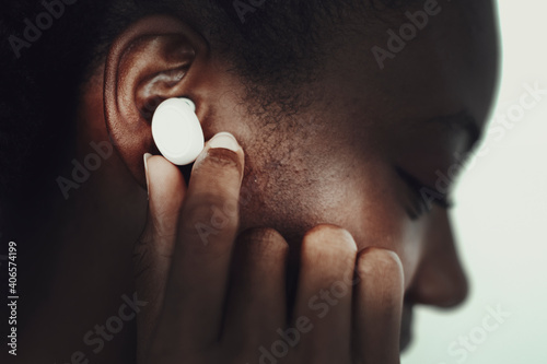 African American woman wearing wireless earbuds
