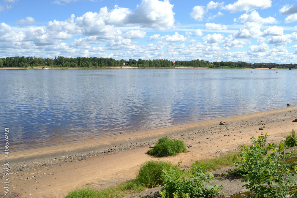 Summer landscape with a river and fluffy white clouds in the sky. Rybinsk, Russia, Volga river. Summer landscape with a river and fluffy white clouds in the sky. Rybinsk, Russia, Volga river.