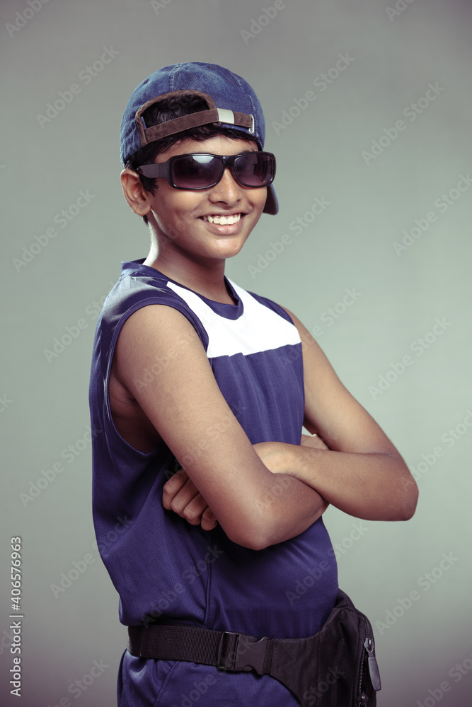 Cheerful Indian teen with sunglass with cap Cheerful Indian teen with sunglass with cap