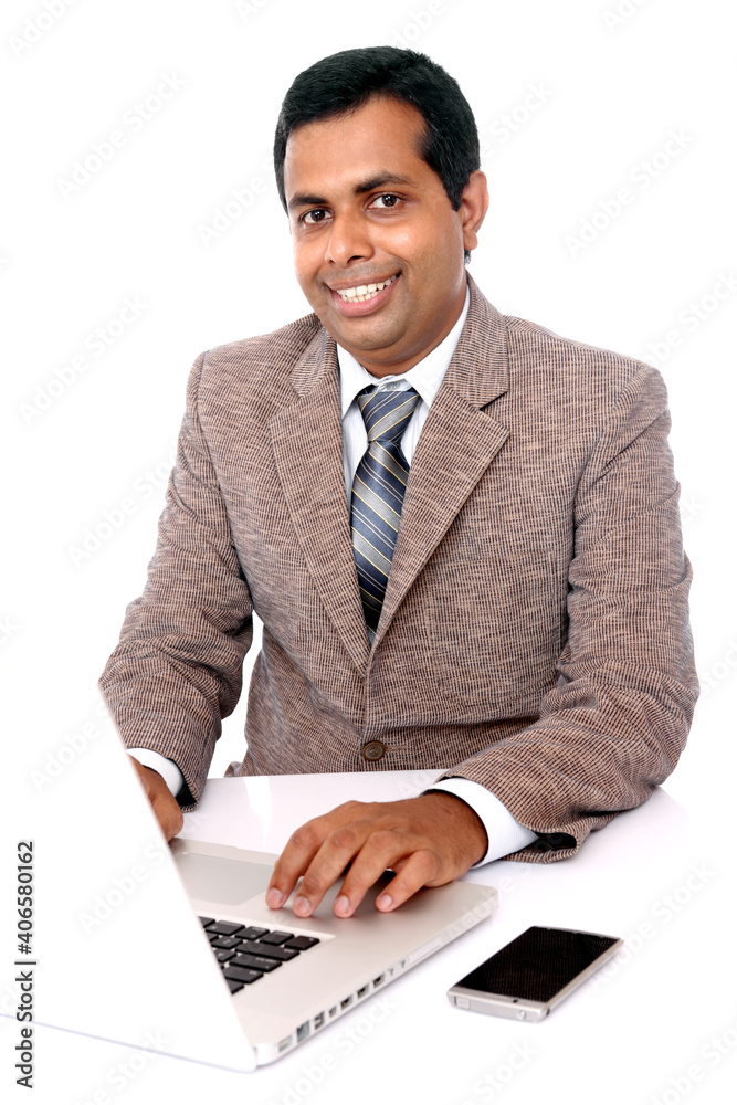 Indian young businessman working in laptop isolated on white. Indian young businessman working in laptop isolated on white.