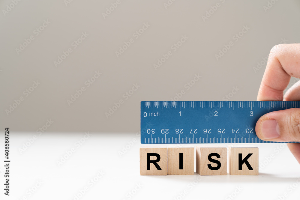 Measure the word risk with blue color ruler for risk assessment concept ...