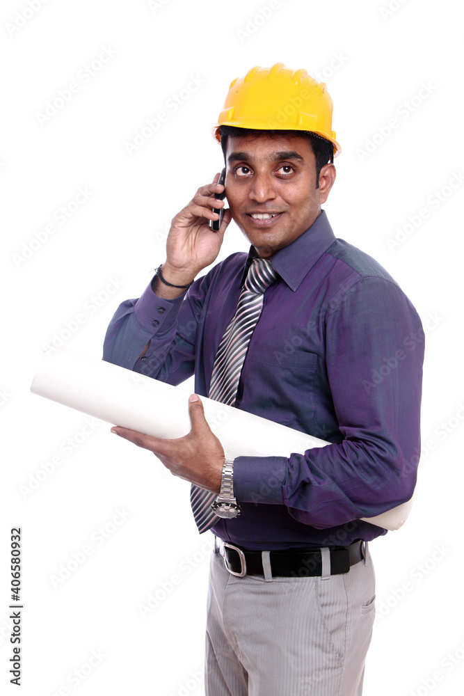 Young Indian architect talking on the phone Young Indian architect talking on the phone