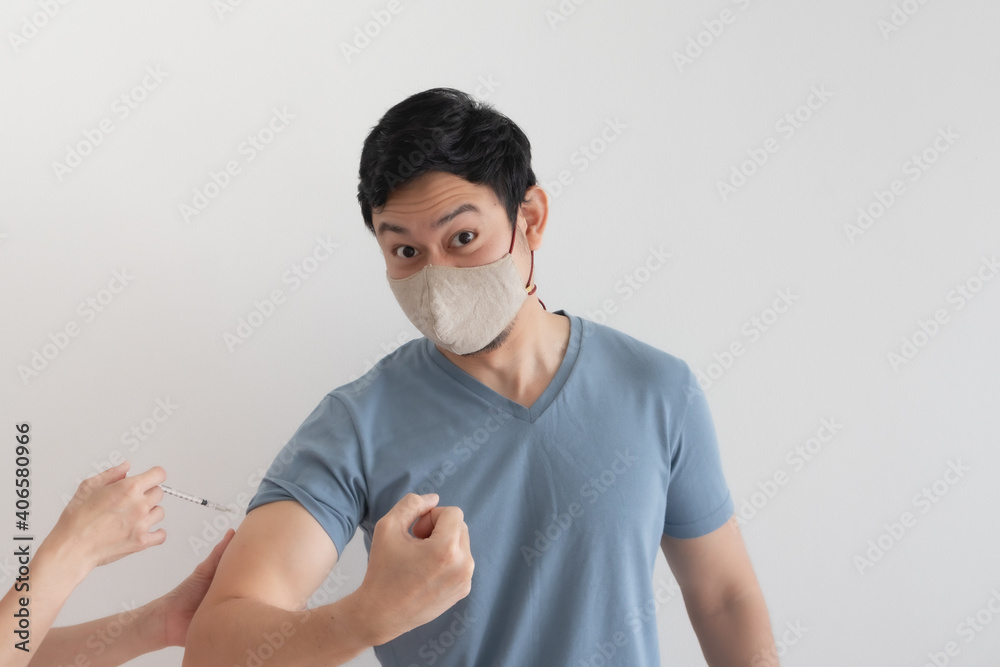Asian man is being injected a vaccine for virus protection. Concept of Covid-19 vaccination.