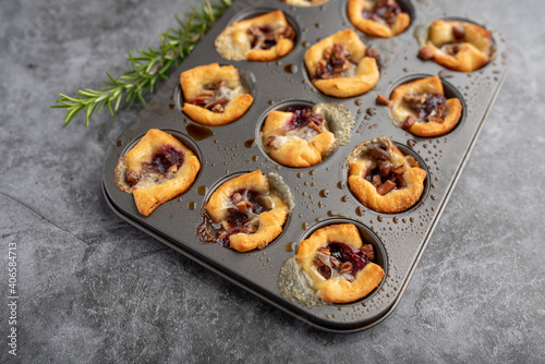 Brie bites with jam and nuts in crescent dough, mini appetizer dessert with cranberry or any jelly