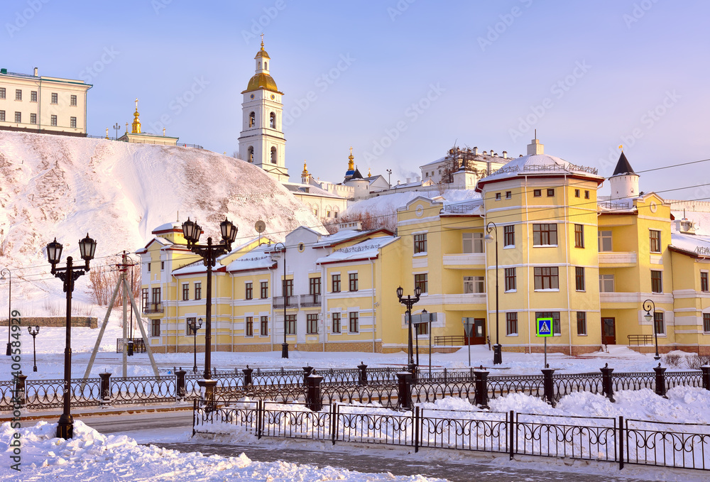 Tobolsk Kremlin in winter. Castle with bell tower on the hill, view from the lower town. Ancient Russian architecture of the XVII century and modern houses in the first capital of Siberia