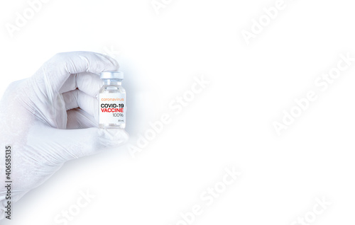 COVID-19 Vaccine concept in hand of scientist white vaccine jar isolated on white background.