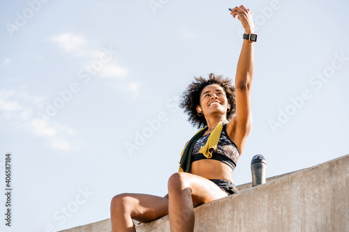 Athlete woman taking a selfie with phone outdoors.