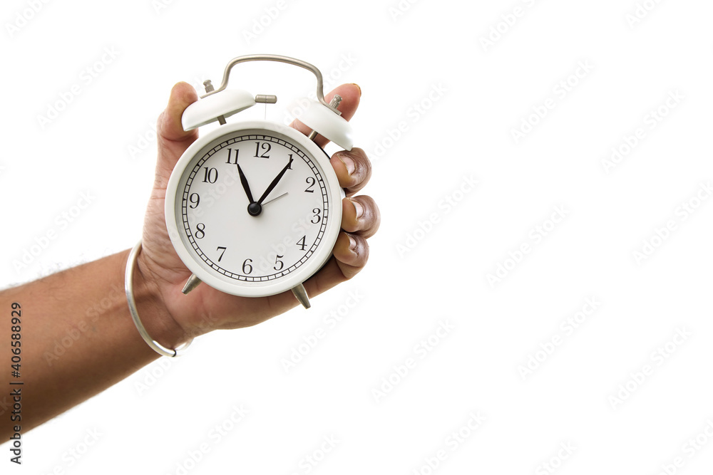 male hand holding alarm clock on white male hand holding alarm clock on white