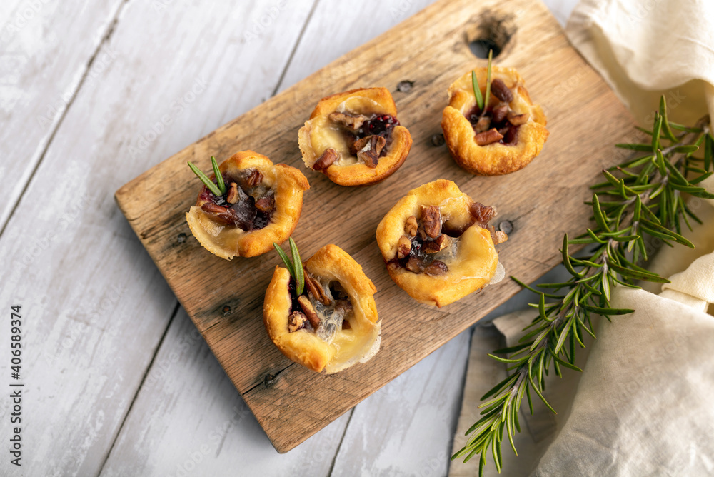 Brie bites with jam and nuts in crescent dough, mini appetizer dessert with cranberry or any jelly