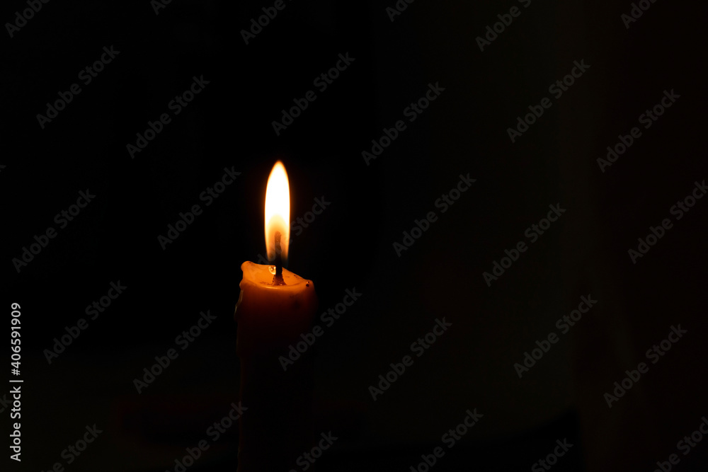 A burning candle in the night