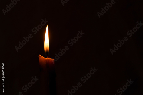 A burning candle in the night