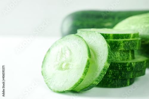 Fresh cucumber slices on white background.