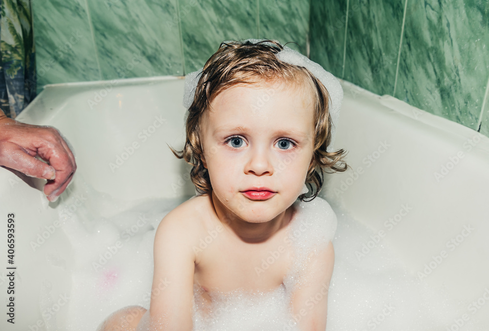 beautiful child toddler son washes in the bathroom plays has fun with soap bubbles,foam beautiful child toddler son washes in the bathroom plays has fun with soap bubbles,foam