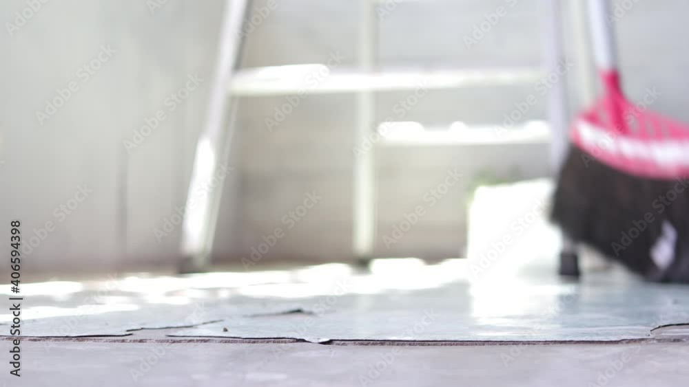 Close up of a man sweeping floor with a broom, home cleaning Close up of a man sweeping floor with a broom, home cleaning