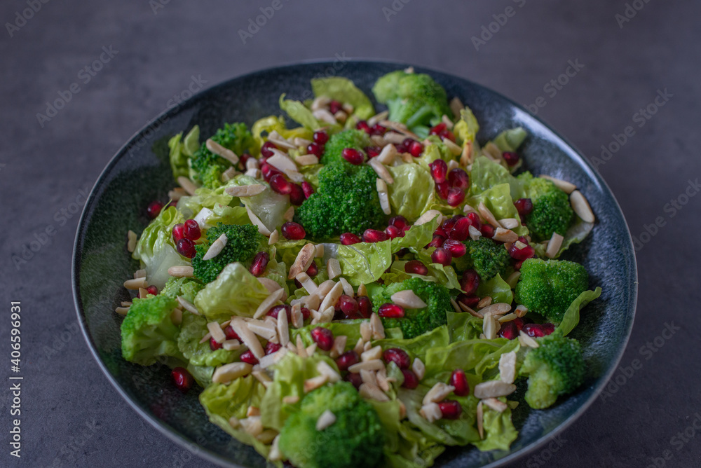 healthy tasty Broccoli salad with pomegranate on a table healthy tasty Broccoli salad with pomegranate on a table