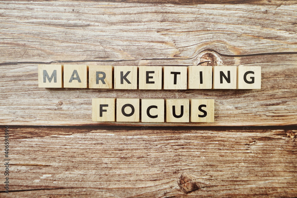 Marketing Focus alphabet letter on wooden background