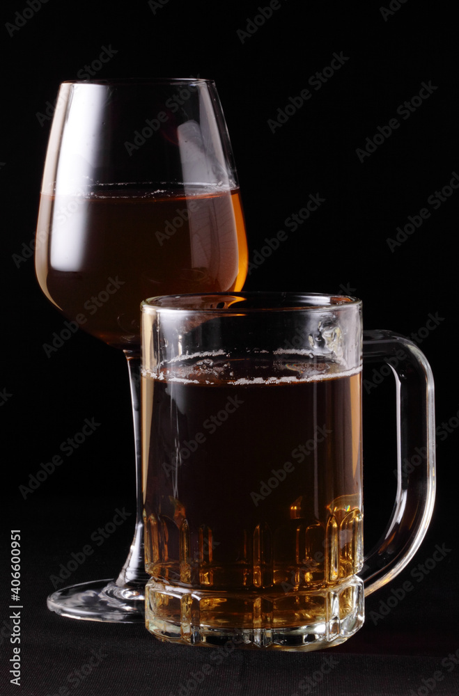 Glass of beer close-up on dark background.