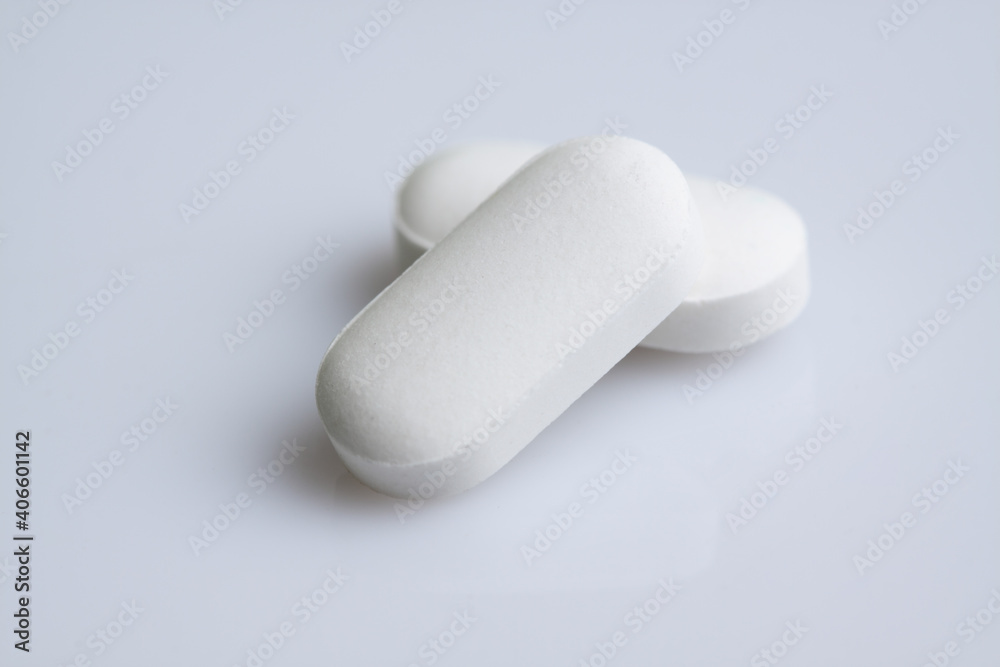 white pills on white background white pills on white background