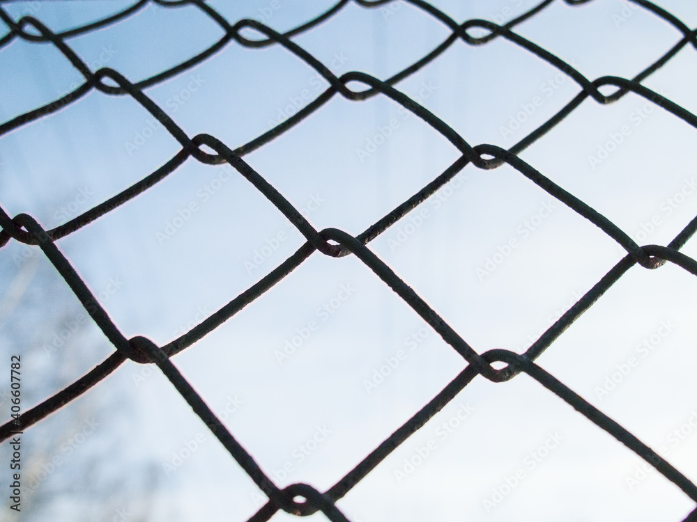 Fototapeta premium Chain-link. Fence against the sky.