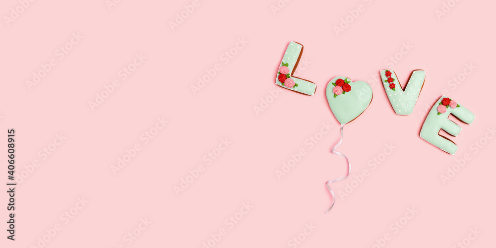 Word Love from homemade ginger biscuits and one in form heart flying as balloon, pink background. Valentines day Holiday sweet food concept. Word Love from homemade ginger biscuits and one in form heart flying as balloon, pink background. Valentines day Holiday sweet food concept.