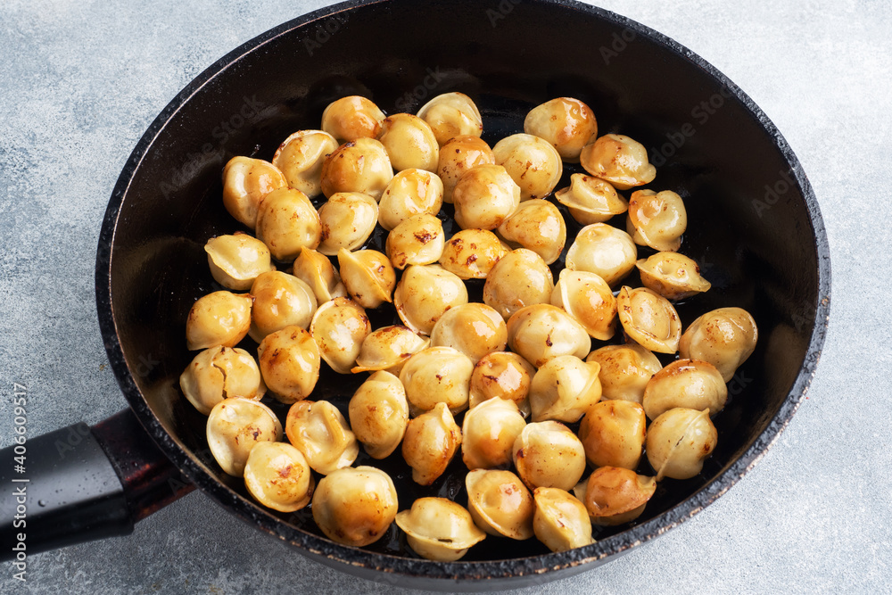 Delicious fried dumplings with meat in a pan. Delicious fried dumplings with meat in a pan.
